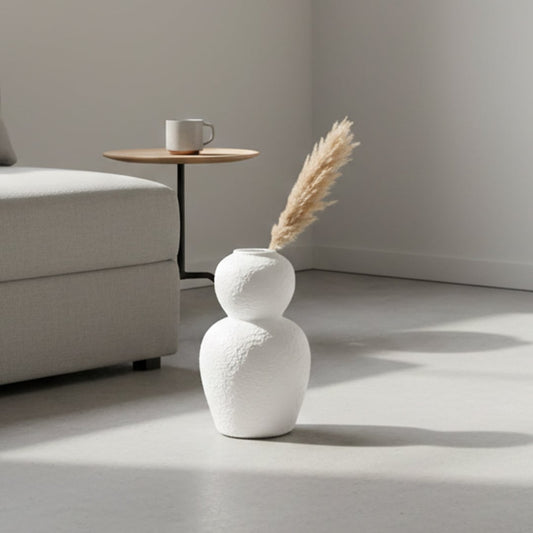 White textured decorative vase arranged in a styled home setting adding sculptural modern decor to living rooms entryways and reading corners.