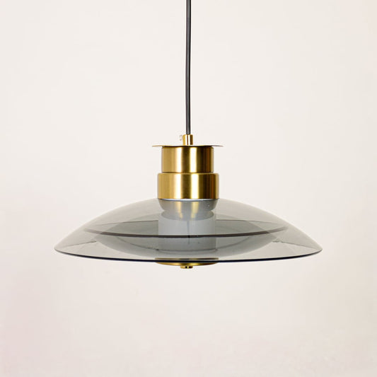 Clear glass and gold metal disc pendant light designed for stylish dining room and kitchen decor.