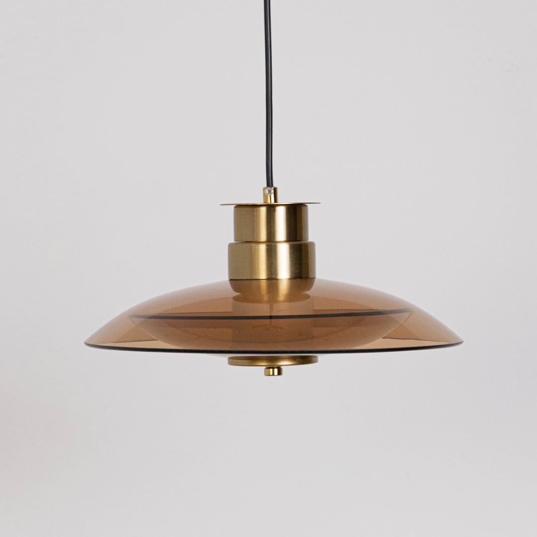 Gold metal disc pendant light designed for kitchen island dining room and modern home decor.