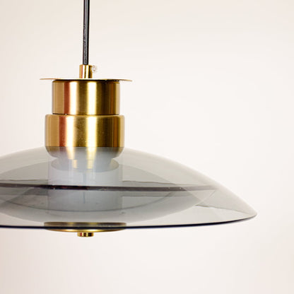 Pendant light closeup showing smoked glass shade with gold metal holder highlighting premium finish for modern ceiling lighting decor.