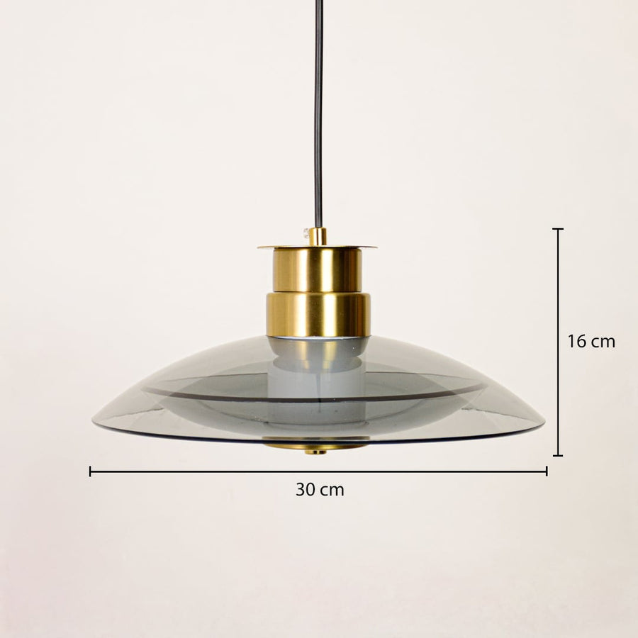 Pendant light with smoked glass shade and gold metal holder suspended from ceiling showing 16 cm height and 30 cm width size.