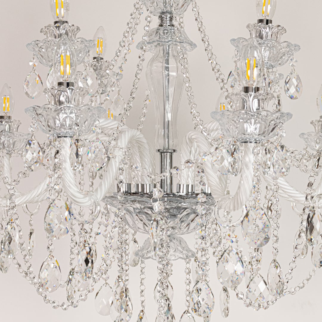 Closeup of large clear crystal chandelier with detailed crystal droplets and curved arms perfect for luxury ceiling decor.