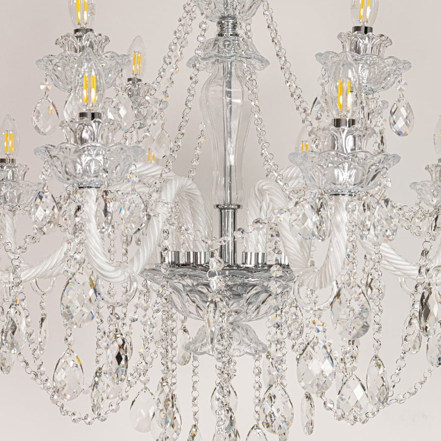 Closeup of large clear crystal chandelier with detailed crystal droplets and curved arms perfect for luxury ceiling decor.