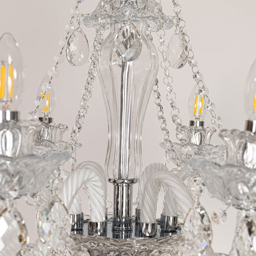 Closeup of clear crystal chandelier with detailed crystal droplets and curved arms perfect for luxury ceiling decor.