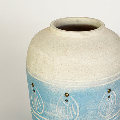 Closeup image of blue ceramic floor vase for modern interior decor styling with textured artistic finish.