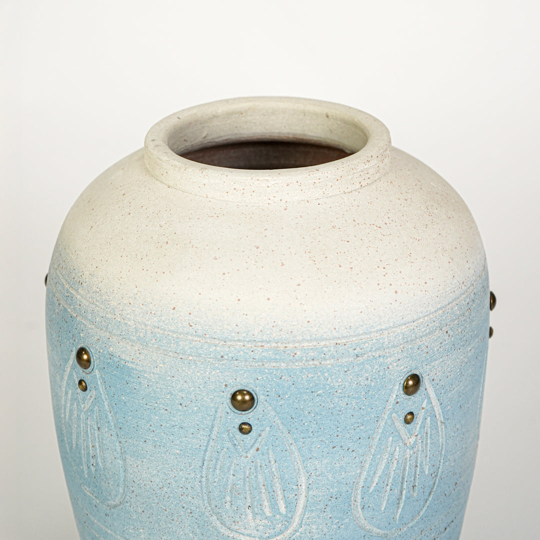 Closeup image of blue ceramic decorative vase for modern tabletop decor styling with textured artistic finish.