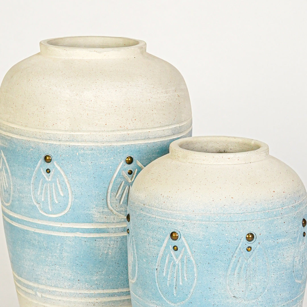Closeup image of blue ceramic decorative vase set for modern interior styling with artistic textured finish.
