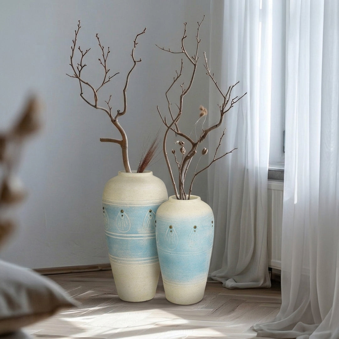 Lifestyle image of blue ceramic vase set for modern living room decor styling with textured matte finish.