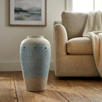 Lifestyle image of blue ceramic floor vase for modern living room decor styling with rustic textured finish.