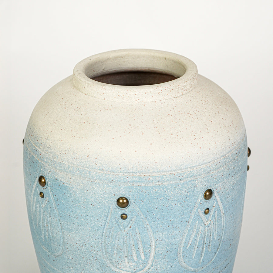 Closeup image of blue ceramic decorative vase for modern tabletop decor styling with textured artistic finish.