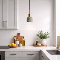 Terracotta terrazzo pendant light above kitchen counter adding artistic warmth and contemporary charm.