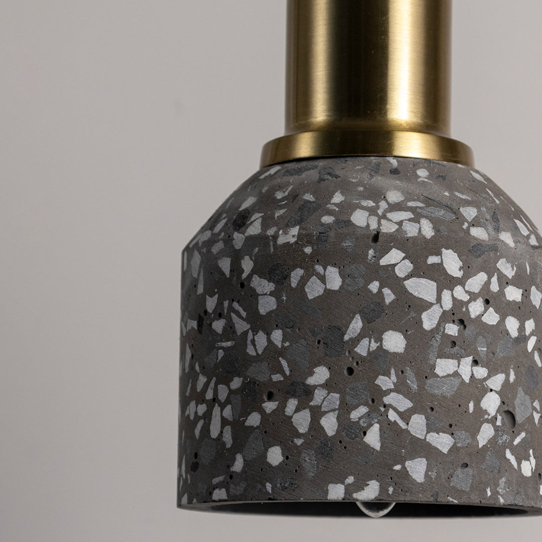 Closeup of black terrazzo pendant light showcasing premium stone texture and refined craftsmanship.
