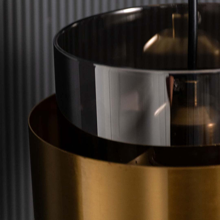 Closeup of black and brass metal pendant light highlighting reflective finish and craftsmanship.
