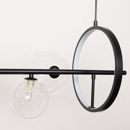 Closeup of modern wall light with black frame clear glass globe and exposed bulb showcasing minimal industrial lighting style.