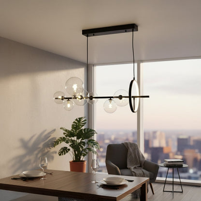 Modern linear pendant light with clear glass globes suspended from black ceiling mount styled in minimal interior setting.