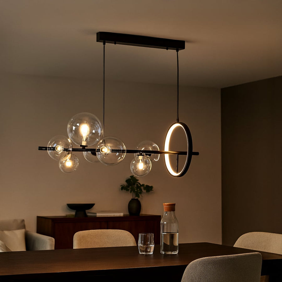 Contemporary hanging pendant light styled in modern space emphasizing horizontal form and elegant glass globes.