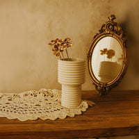 Single dried sola flower stem styled in ceramic vase adds earthy natural charm to modern minimalist home decor.