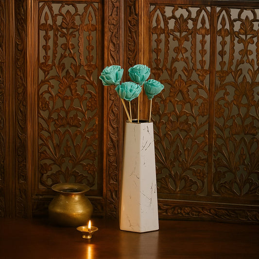 White marble vase styled with blue dried flower stems elegant home decor accent for living room and table styling.