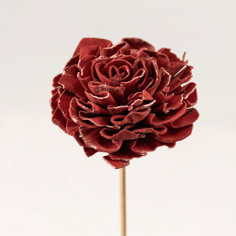 Closeup view of red sola flower head with layered petals creating a realistic artificial flower for elegant vase decoration.
