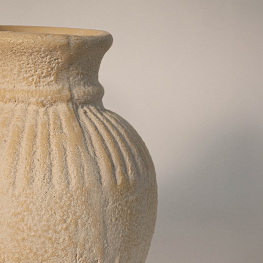 Close up of textured ribbed vase highlighting detailed ceramic ridges and matte handcrafted surface.