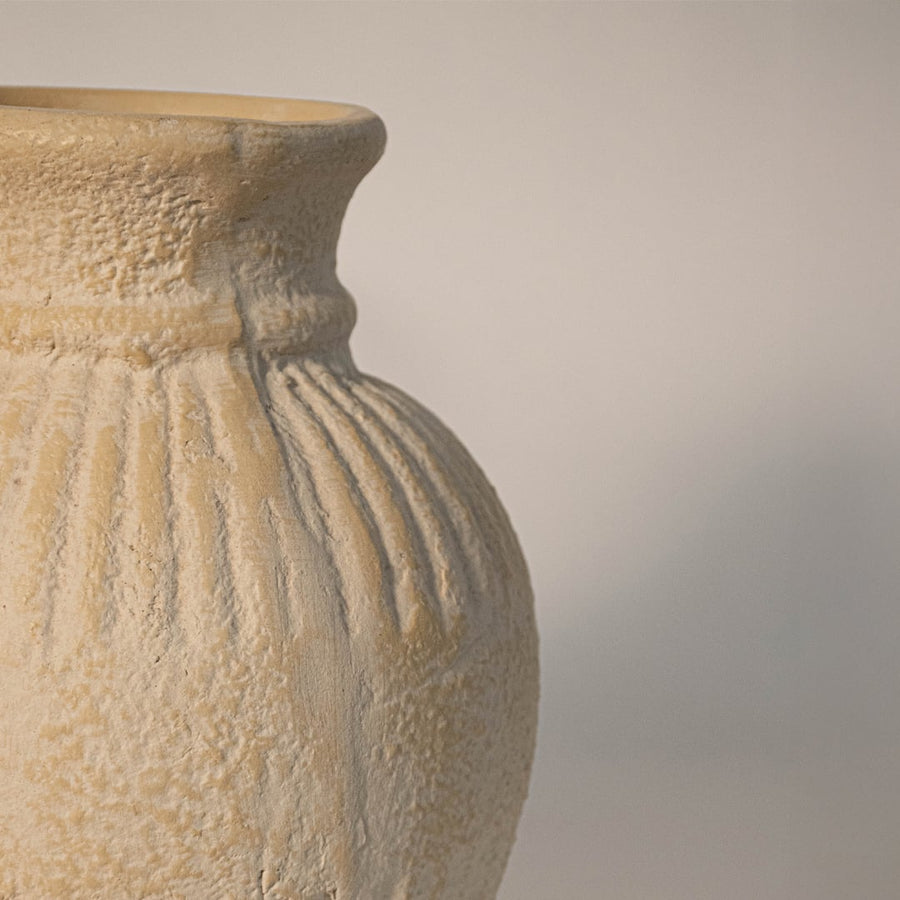 Close up of textured ribbed vase highlighting detailed ceramic ridges and matte handcrafted surface.