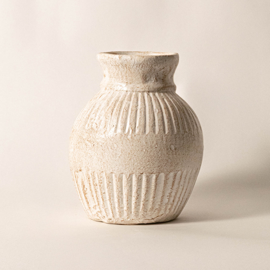 Elegant ceramic vase in off white finish with detailed texture for table decor or shelf styling contemporary home placement white background.