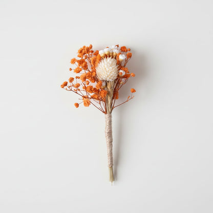 Dried floral stem bouquet with orange blossoms and ivory center on white background highlighting warm tones natural texture handcrafted decor elegance.