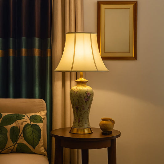 Elegant ceramic table lamp with floral design and golden base styled on side table adding charm to luxury interiors.