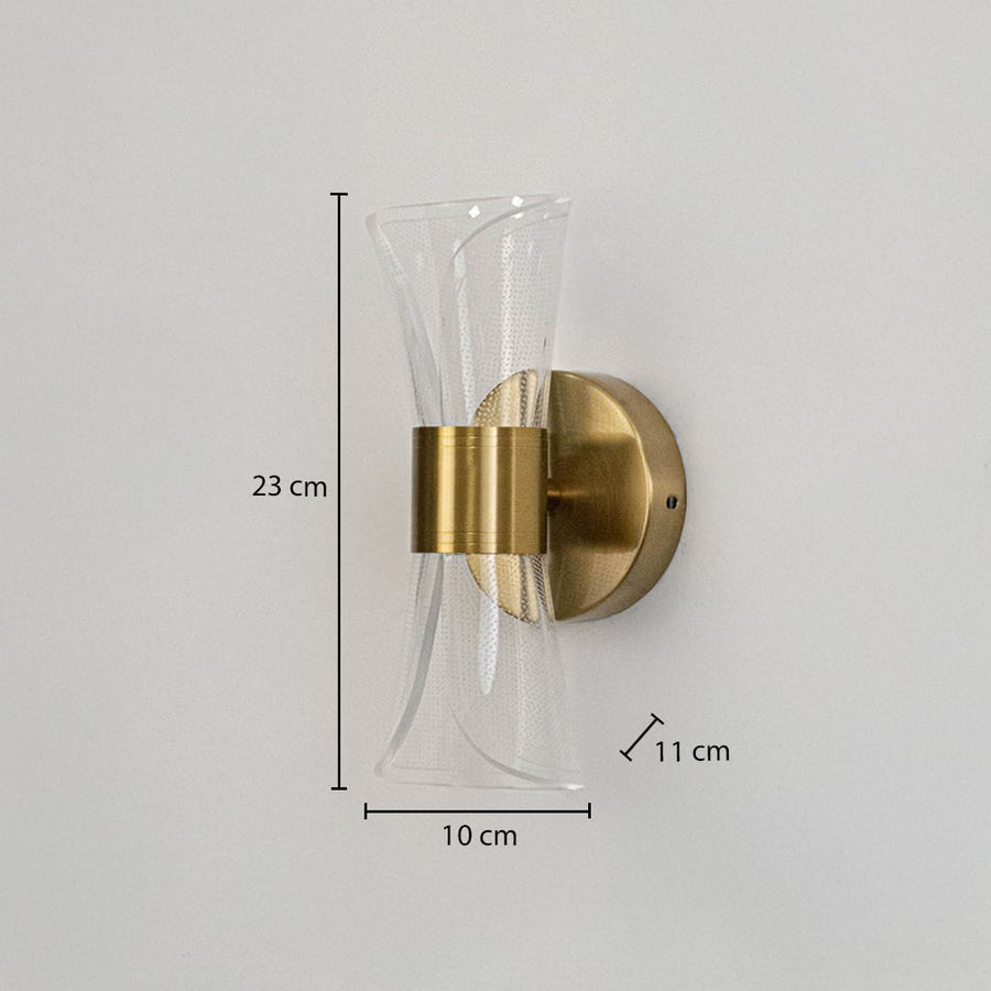 Gold wall light with sculpted clear glass shade shown with 23 cm height and 10 cm width for accurate sizing.