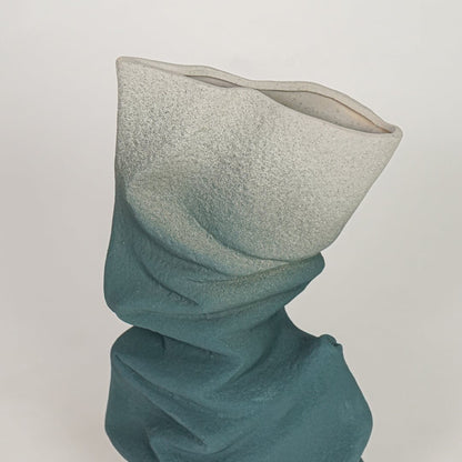 Closeup of blue ceramic vase with textured twisted finish for elegant tabletop and shelf decor styling ideas.