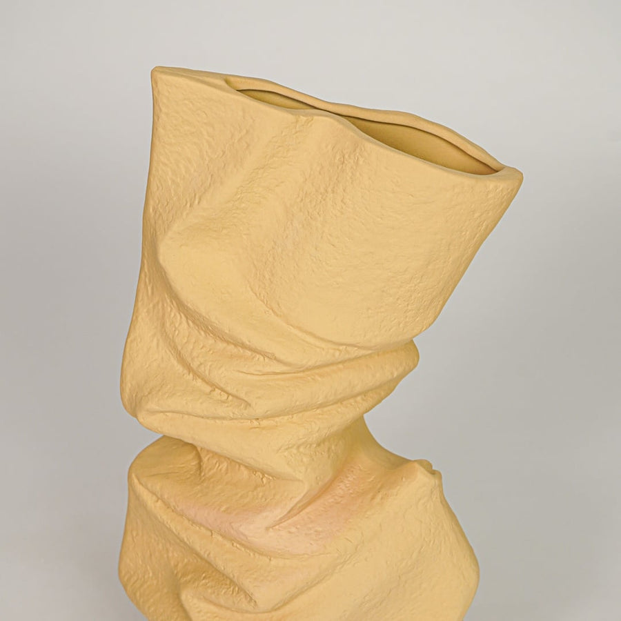 sorting hat crumpled ceramic vase yellow closeup