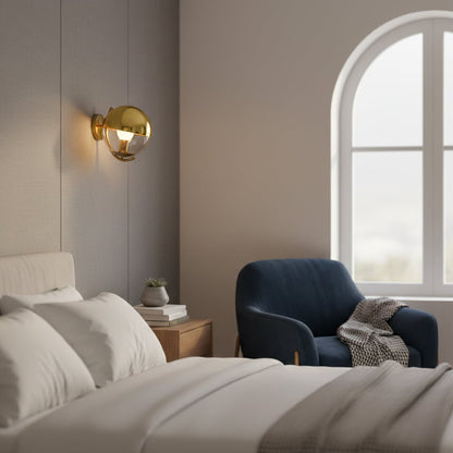 Modern gold metal wall light with white glass globe for contemporary bedroom and luxury decor spaces.

