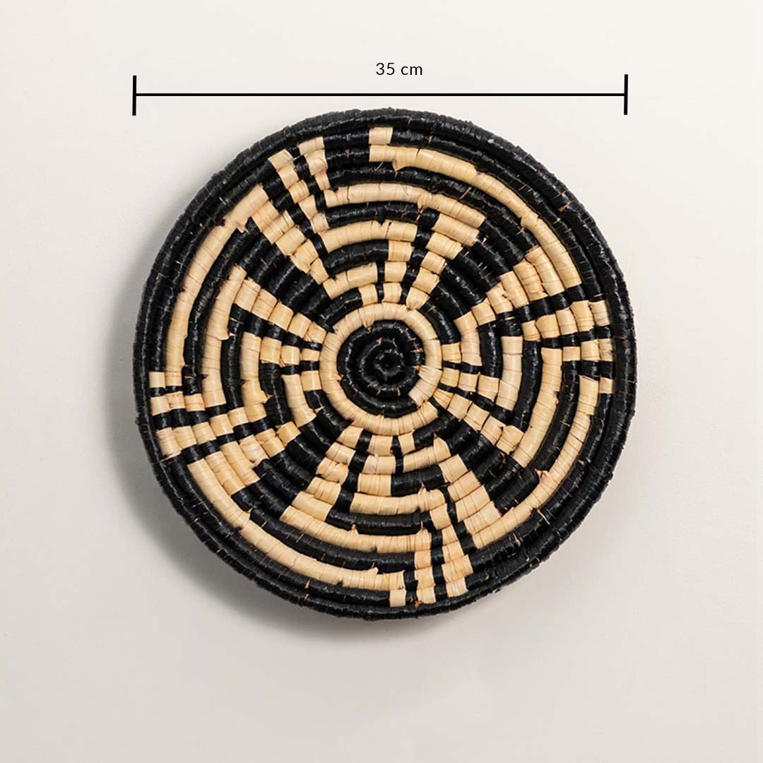 A handwoven black and natural rattan wall basket decor plate shown on a white background with a clear diameter of 35 cm displayed for accurate wall decor measurements.