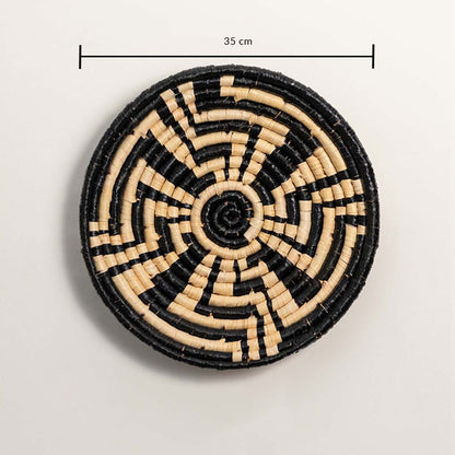 A handwoven black and natural rattan wall basket decor plate shown on a white background with a clear diameter of 35 cm displayed for accurate wall decor measurements.
