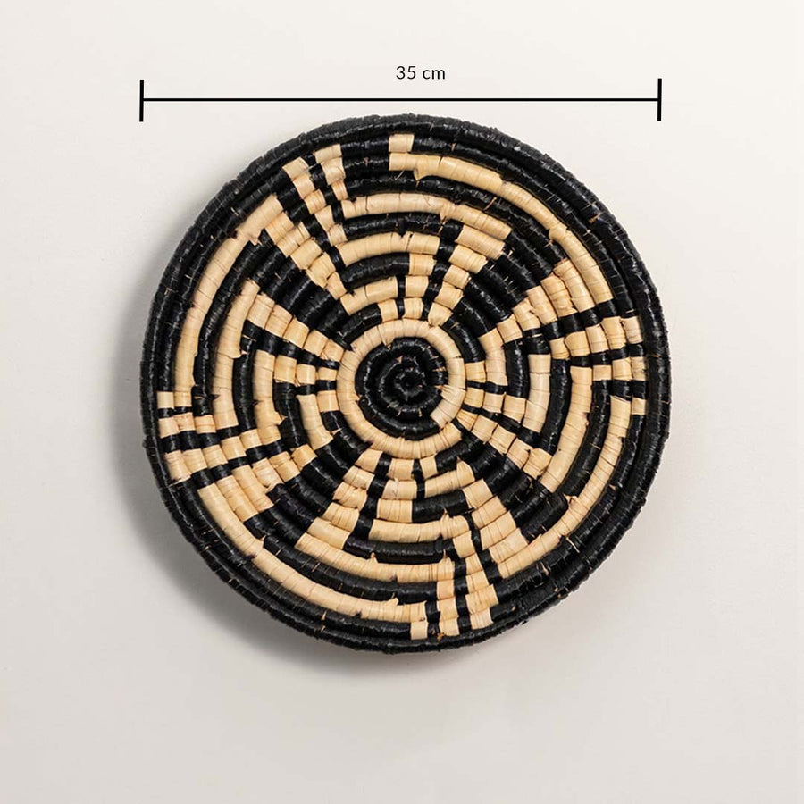 A handwoven black and natural rattan wall basket decor plate shown on a white background with a clear diameter of 35 cm displayed for accurate wall decor measurements.