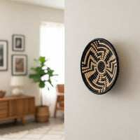 Black and natural woven wall basket displayed as statement wall art for elegant bohemian home decor and interiors.