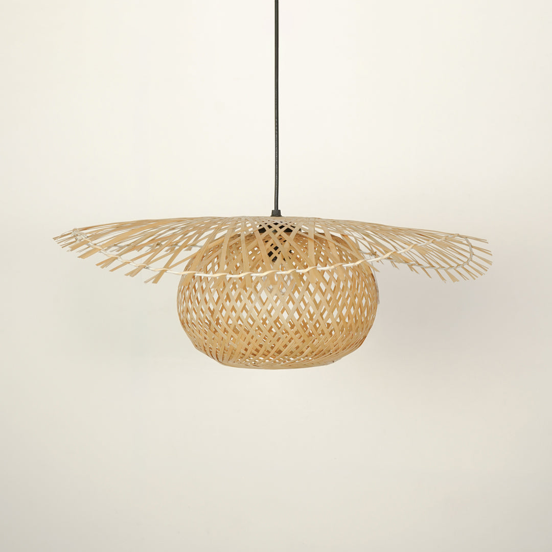 Handwoven rattan pendant light with intricate weave crafted for bohemian interiors.