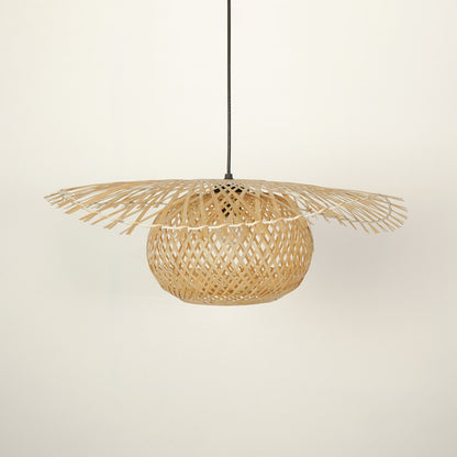 Handwoven rattan pendant light with intricate weave crafted for bohemian interiors.
