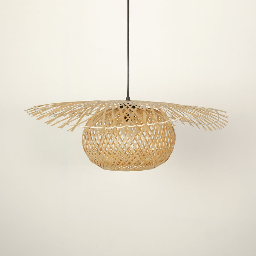Handwoven rattan pendant light with intricate weave crafted for bohemian interiors.