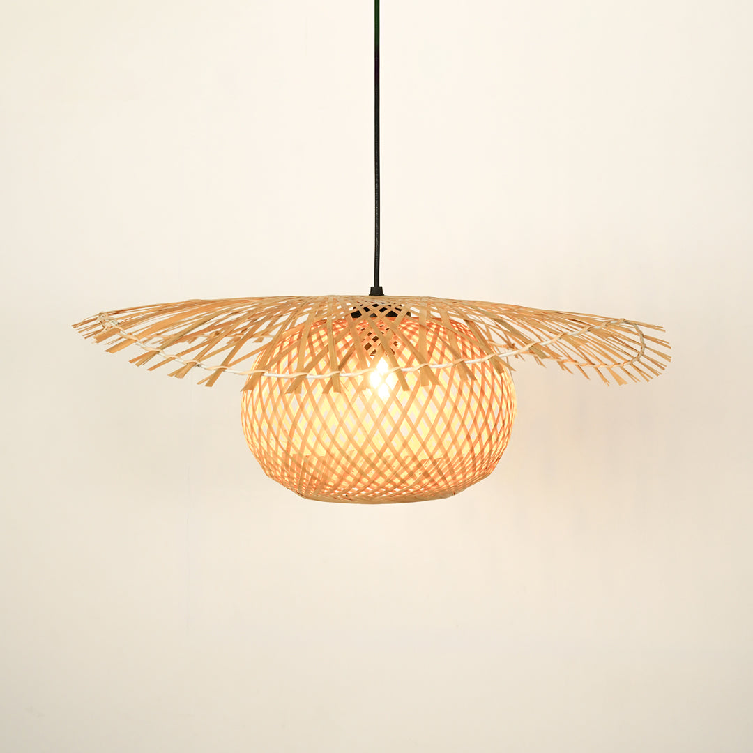 Handwoven rattan pendant light with wide shade illuminated for natural home decor.