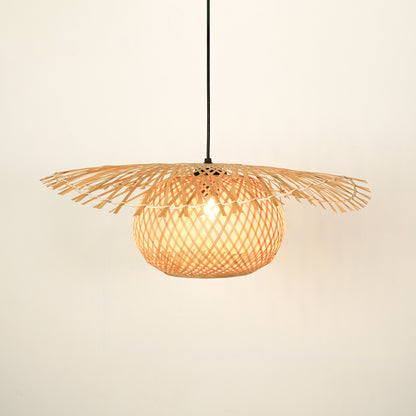 Handwoven rattan pendant light with wide shade illuminated for natural home decor.