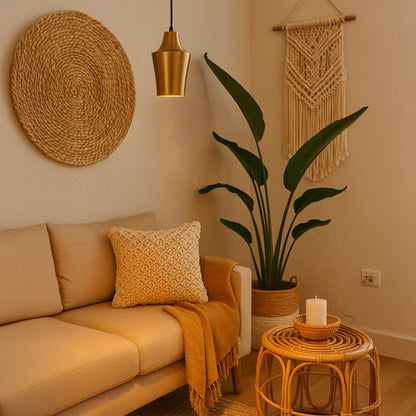 Gold metal pendant light adding warm elegance above the sofa in modern living room decor with natural accents.