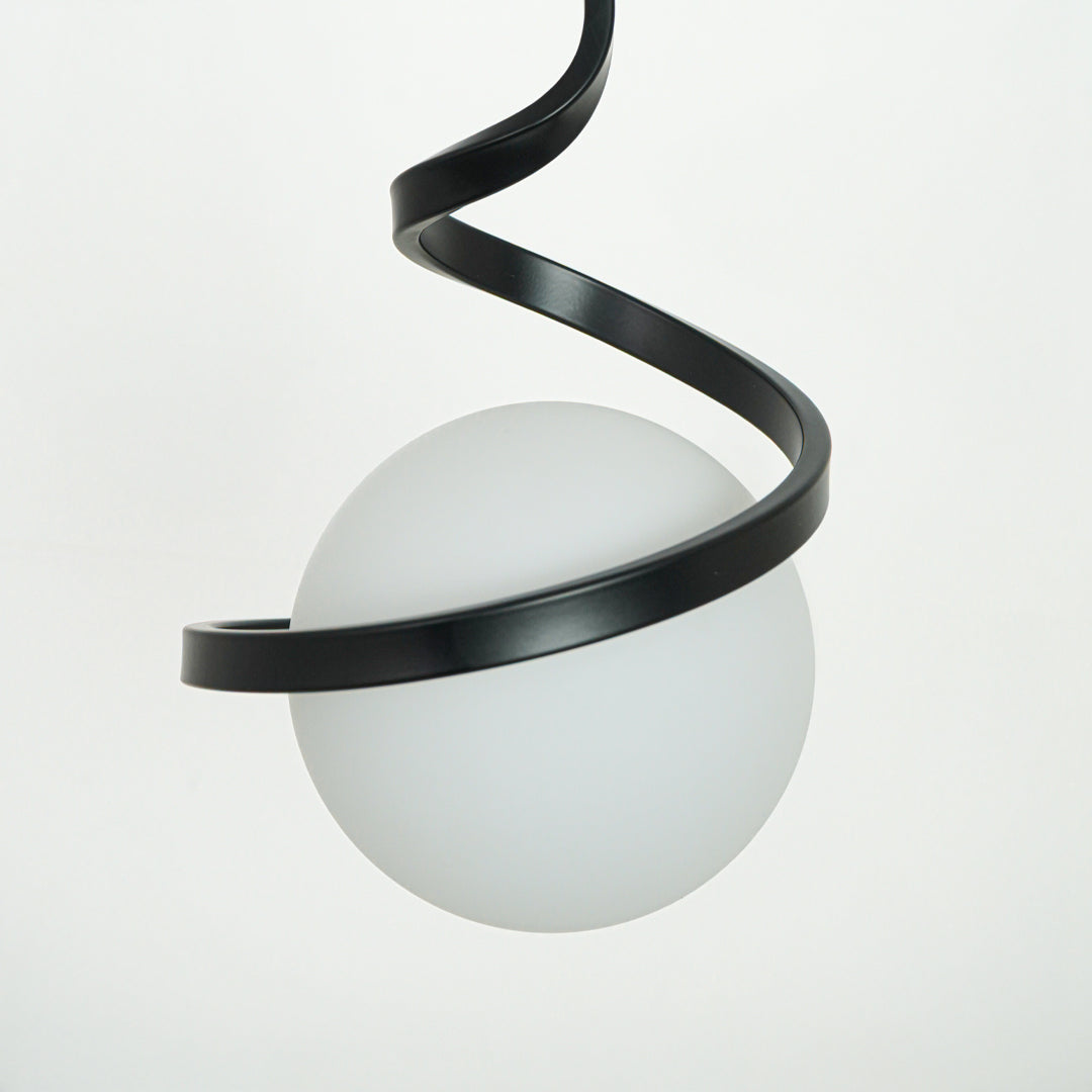 Closeup of black metal spiral pendant light showcasing sleek curves and premium craftsmanship.