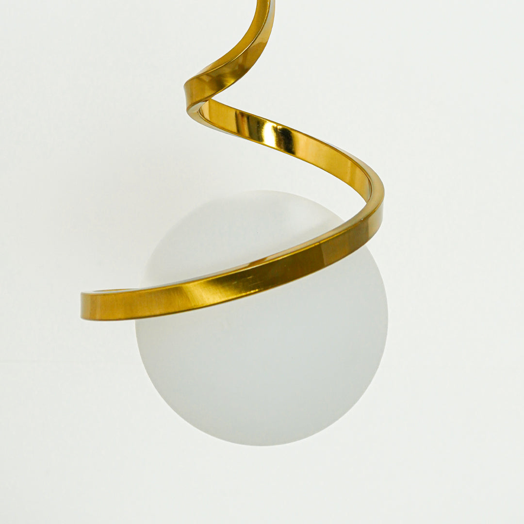 Detailed view of gold metal spiral pendant light with white glass globe and refined craftsmanship.