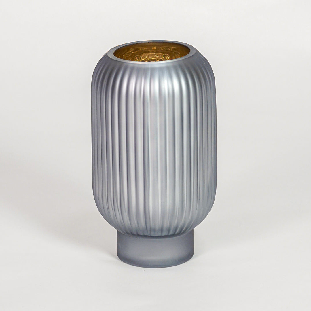 Modern grey ribbed glass vase for minimalist home decor and elegant shelf display accent in contemporary style.