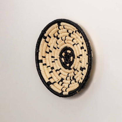 Side view of handcrafted black cream seagrass wall basket with geometric line pattern for modern bohemian home wall décor.