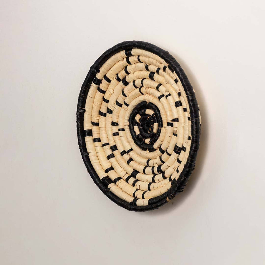 Side view of handcrafted black cream seagrass wall basket with geometric line pattern for modern bohemian home wall décor.