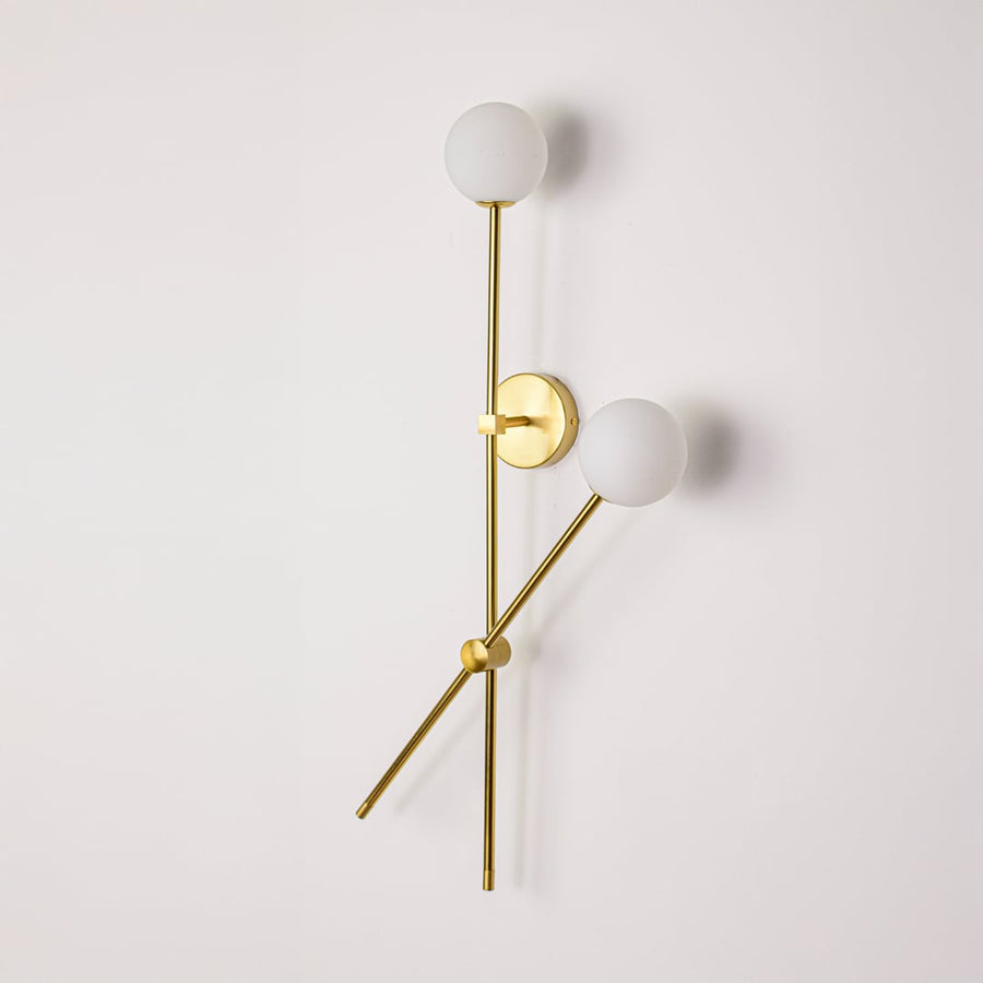 Wall light turned off on white background showcasing clean metal lines frosted glass globes and minimalist vertical design.