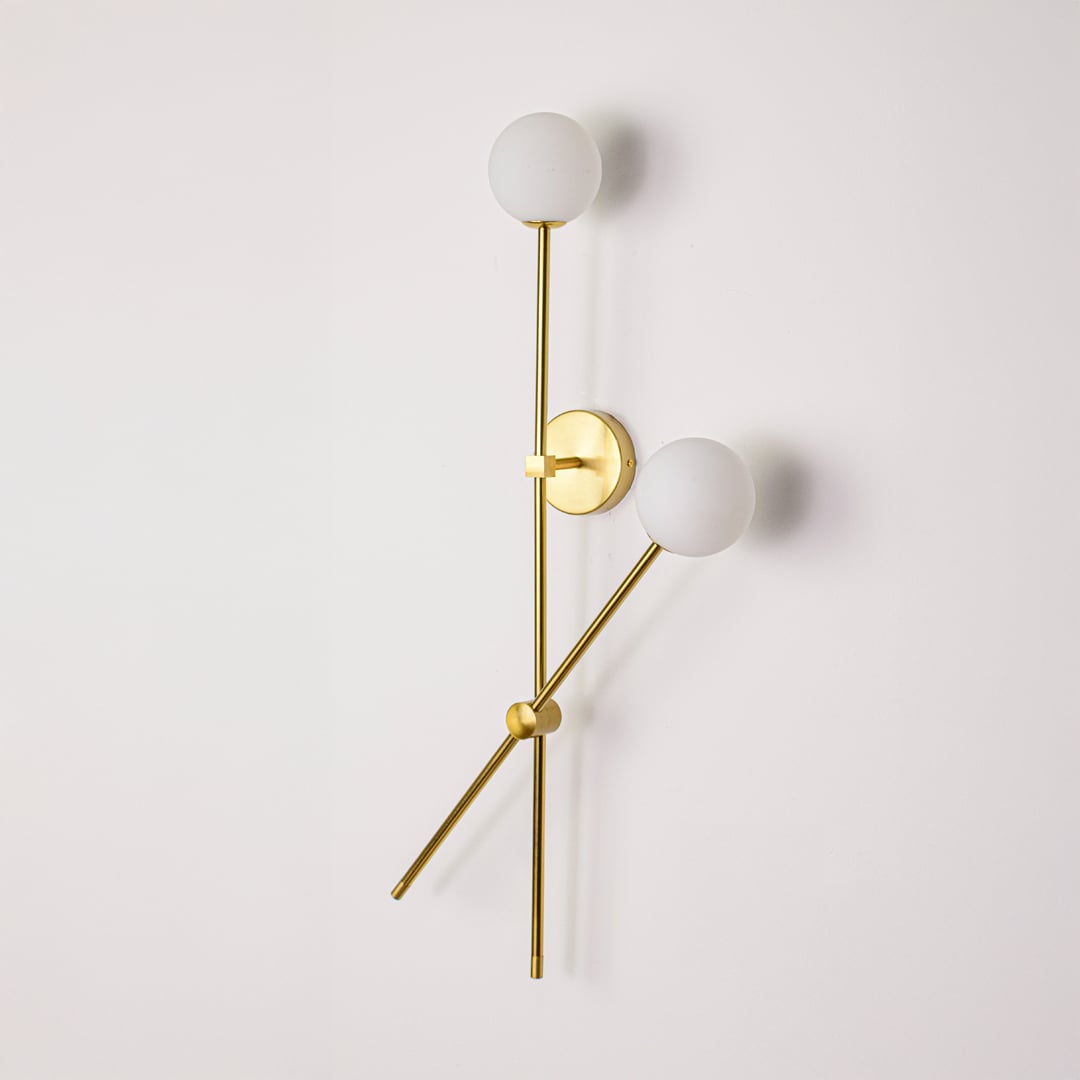 Wall light turned off on white background showcasing clean metal lines frosted glass globes and minimalist vertical design.