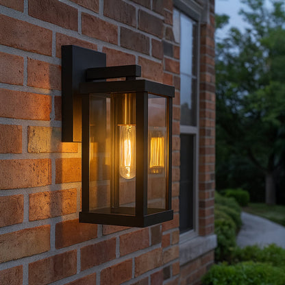 Black metal outdoor wall light mounted on exterior wall with clear glass panels creating modern and elegant outdoor lighting.